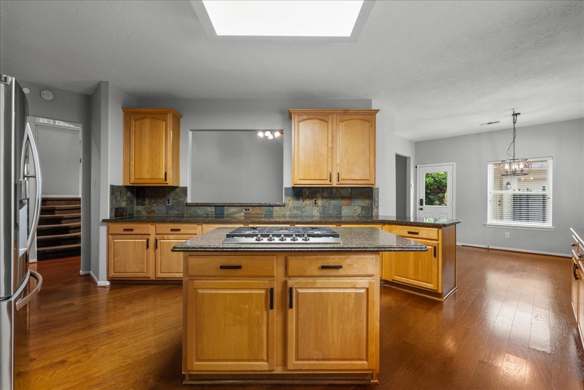 2876 Match Point Lane Friendswood, TX 77546 - Photo 12 of 45 Center gas cooktop in this island provides the perfect working triangle in this kitchen.