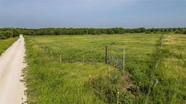 a view of a field with an ocean view