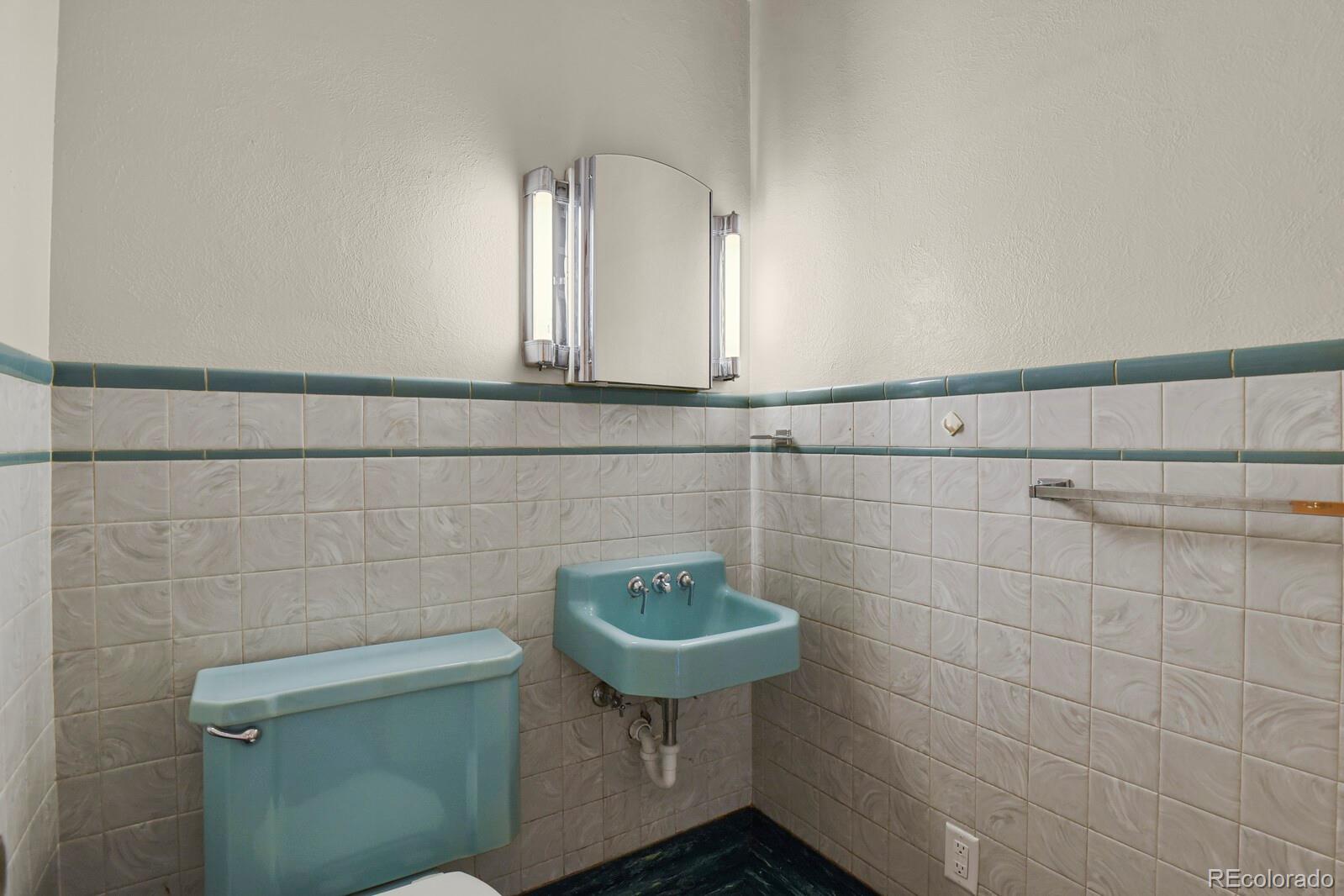425 West Cheyenne Road Colorado Springs, CO 80906 - Photo 17 of 28 a bathroom with a sink a toilet and a mirror