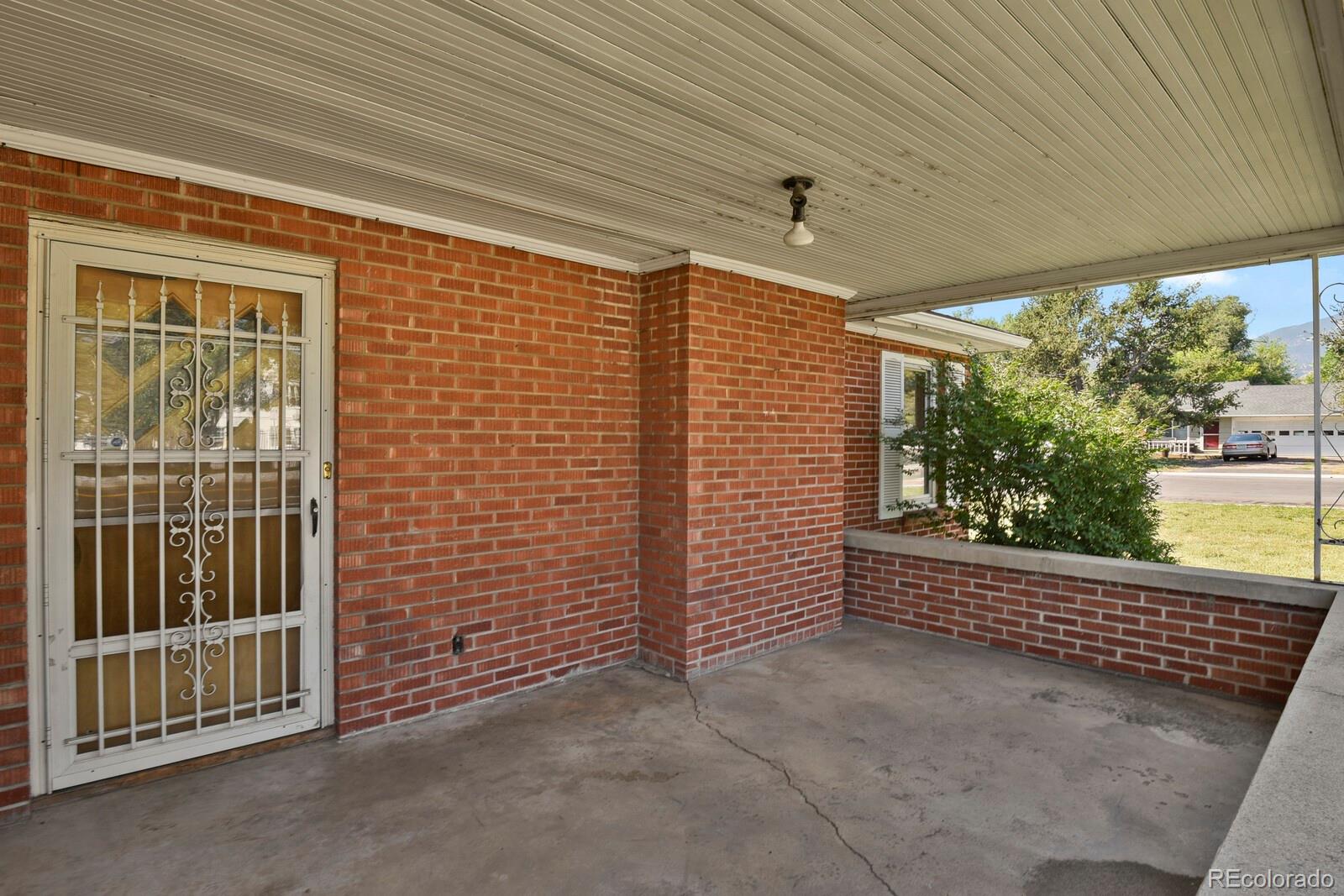 425 West Cheyenne Road Colorado Springs, CO 80906 - Photo 4 of 28 a view of a porch with wooden floor and a floor to ceiling window