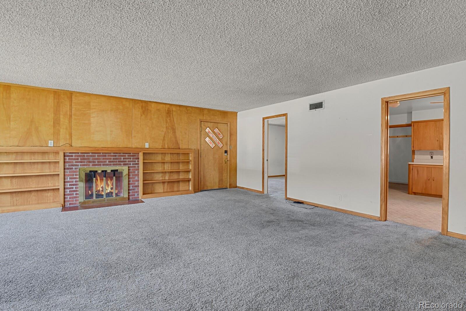 425 West Cheyenne Road Colorado Springs, CO 80906 - Photo 6 of 28 a view of an empty room with a fireplace and a window