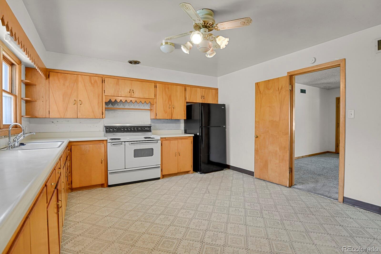 425 West Cheyenne Road Colorado Springs, CO 80906 - Photo 8 of 28 a kitchen with a refrigerator a stove top oven a sink and dishwasher