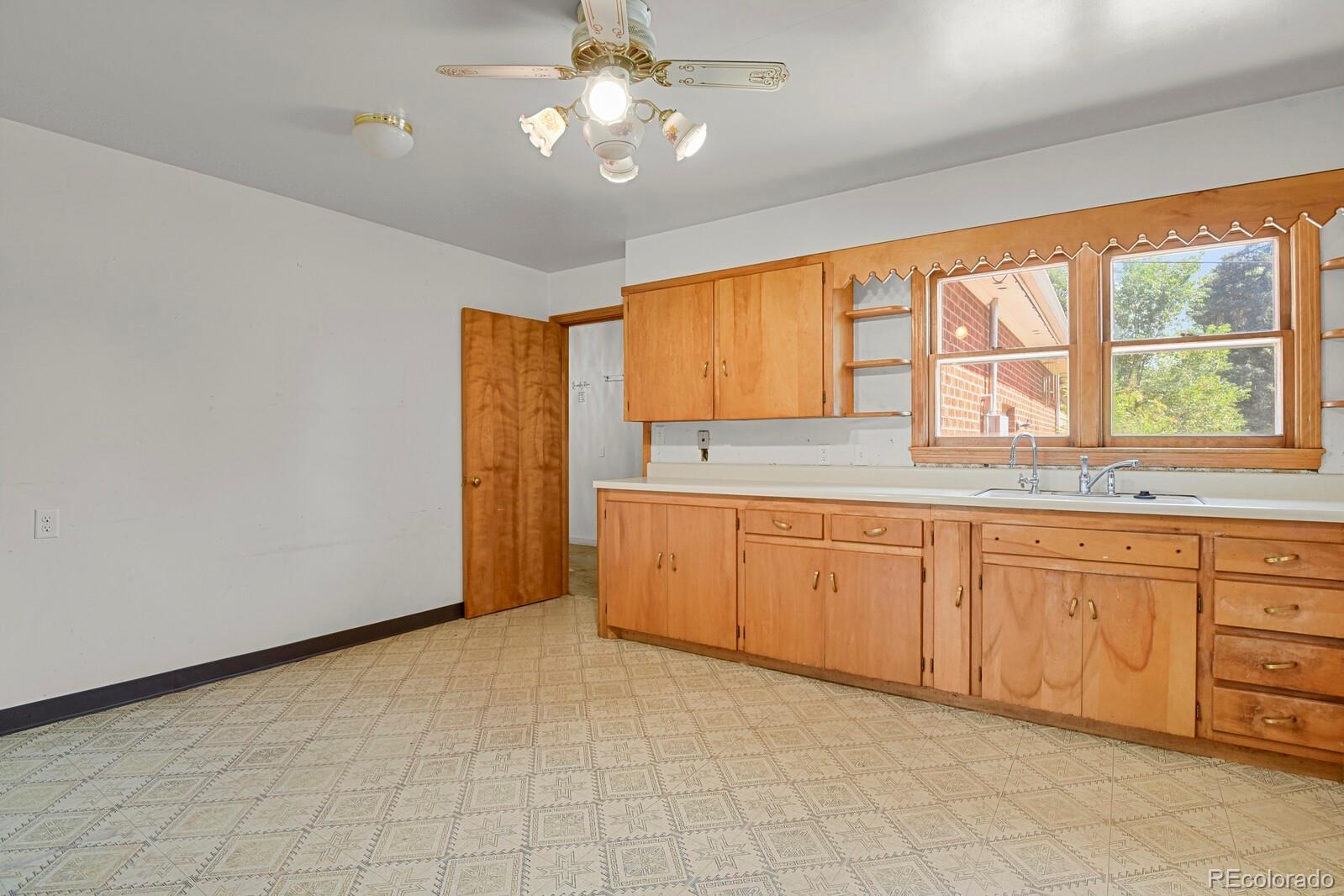 425 West Cheyenne Road Colorado Springs, CO 80906 - Photo 10 of 28 a spacious bathroom with a granite countertop sink and a window