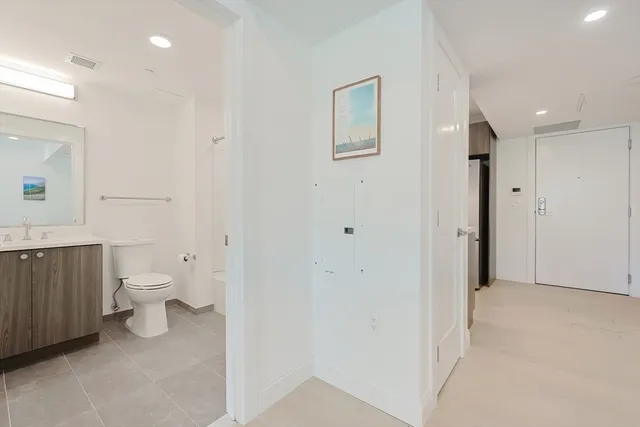 a bathroom with a toilet sink and a mirror