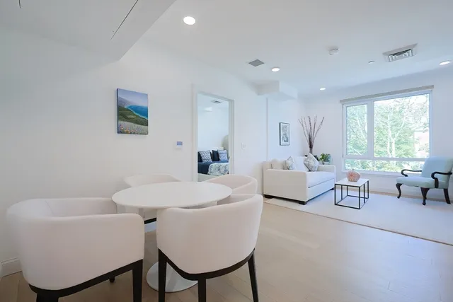 a living room with furniture a window and a table