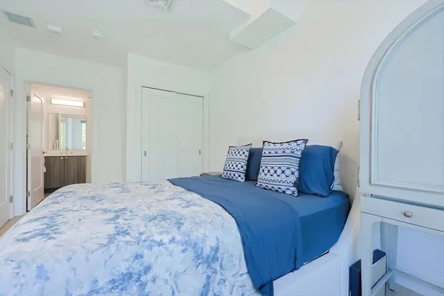 a large bed in a white room