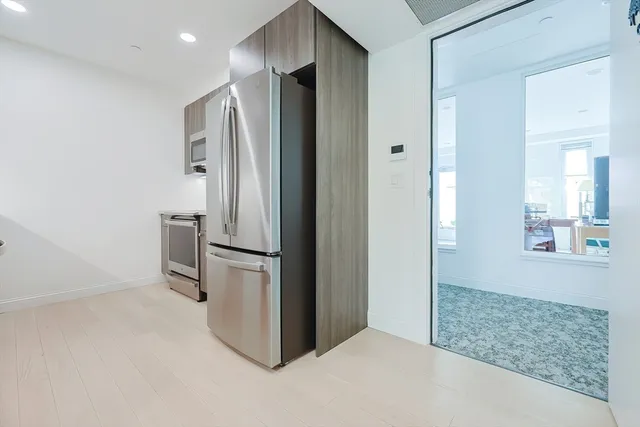 a kitchen with stainless steel appliances a refrigerator and a sink