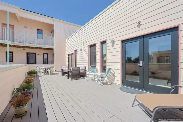 a view of a patio with couches table and chairs and potted plants
