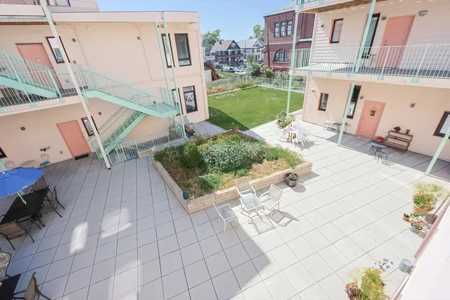 a view of a patio with furniture and a fire pit