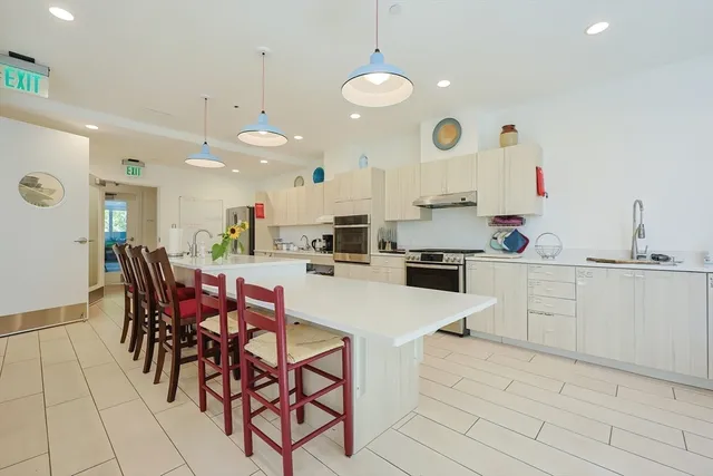 a large kitchen with a table and chairs in it