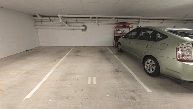 a view of a car garage with a car parked