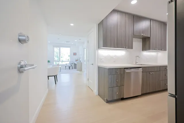 a kitchen with kitchen island white cabinets and sink