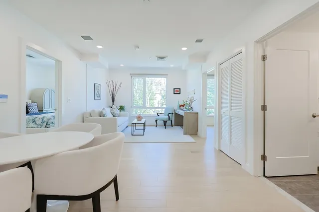 a living room with furniture a wooden floor and a sink