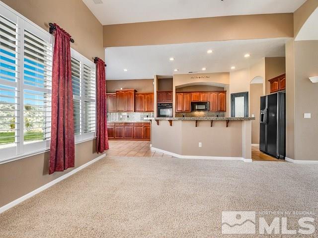 7265 Tempe Court Reno, NV 89511 - Photo 6 of 24 a view of a kitchen with kitchen island a large window appliances and cabinets