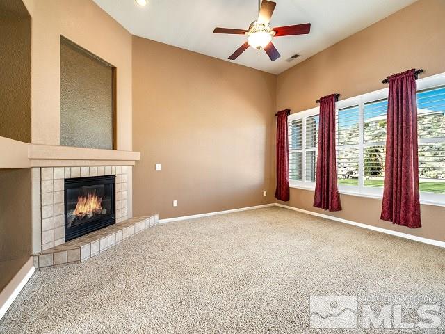 7265 Tempe Court Reno, NV 89511 - Photo 9 of 24 an empty room with windows and fireplace