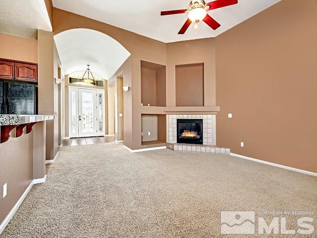 7265 Tempe Court Reno, NV 89511 - Photo 10 of 24 a view of an empty room with a fireplace and a window