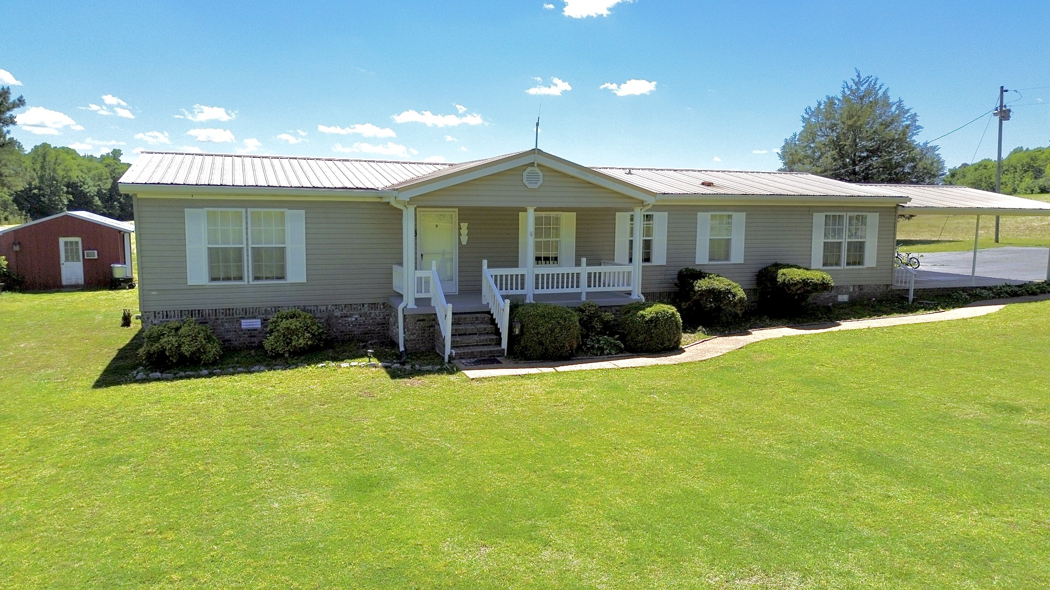 6439 Cedar Grove Road Big Sandy, TN 38221 - Photo 29 of 38 a front view of a house with a yard and porch