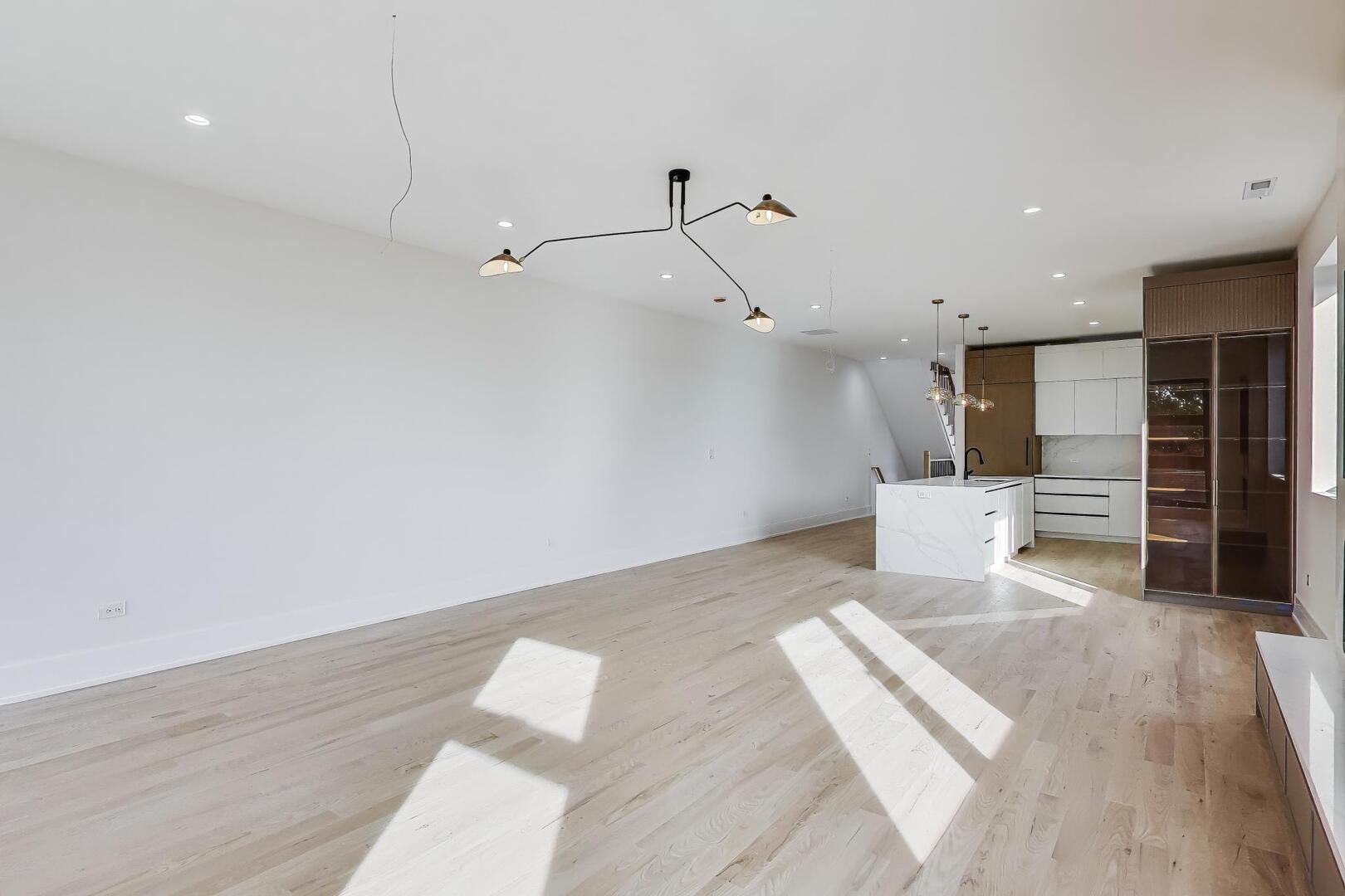 2307 West Foster Avenue, Unit 1 Chicago, IL 60625 - Photo 12 of 34 a view of a room with wooden floor and window