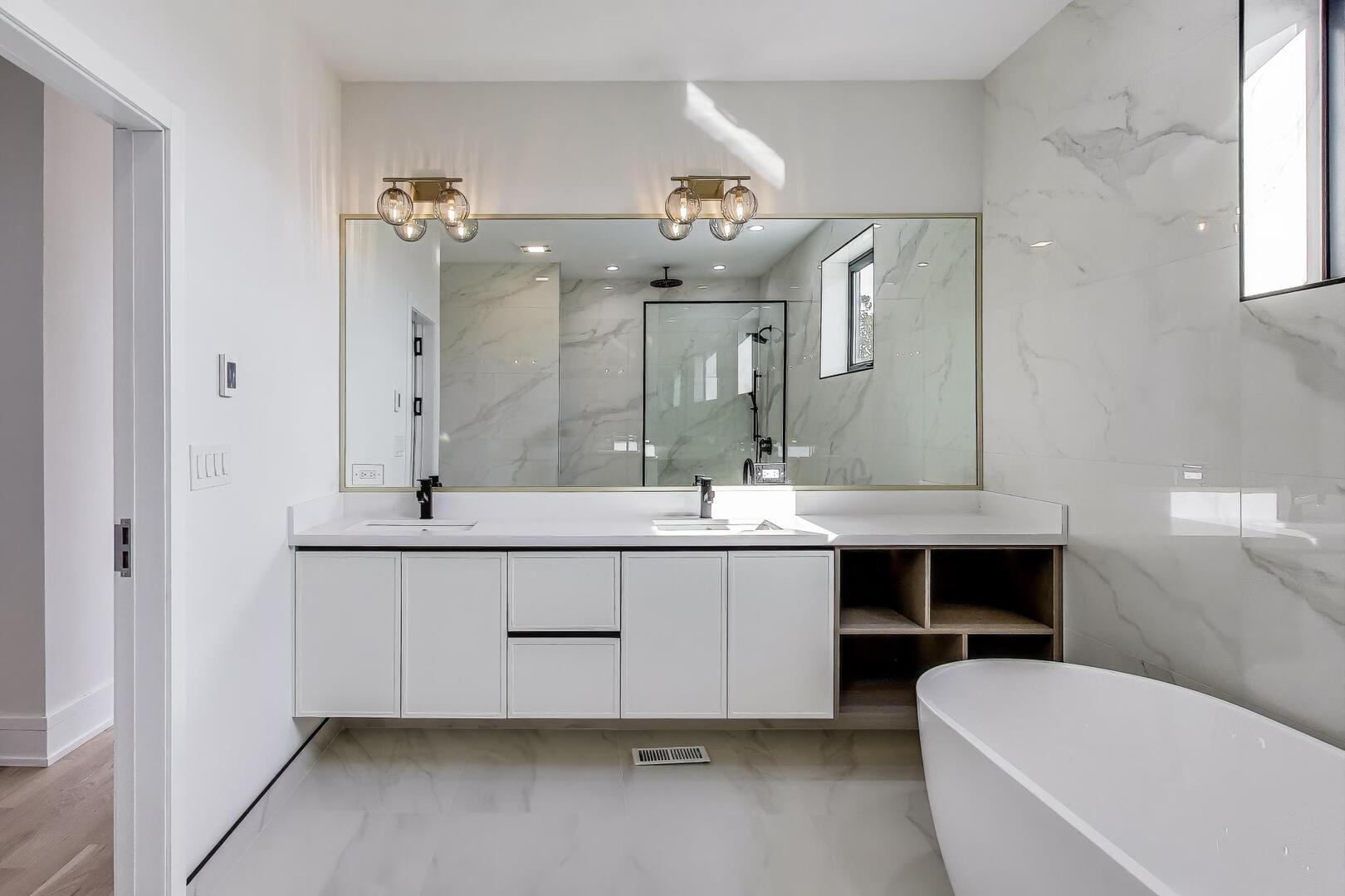 2307 West Foster Avenue, Unit 1 Chicago, IL 60625 - Photo 21 of 34 a spacious bathroom with a double vanity sink mirror and bathtub