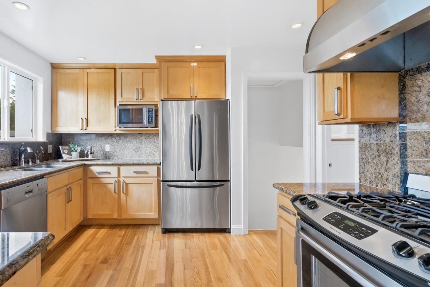 511 Bayview Avenue Millbrae, CA 94030 - Photo 16 of 36 a kitchen with a stove a sink and a refrigerator