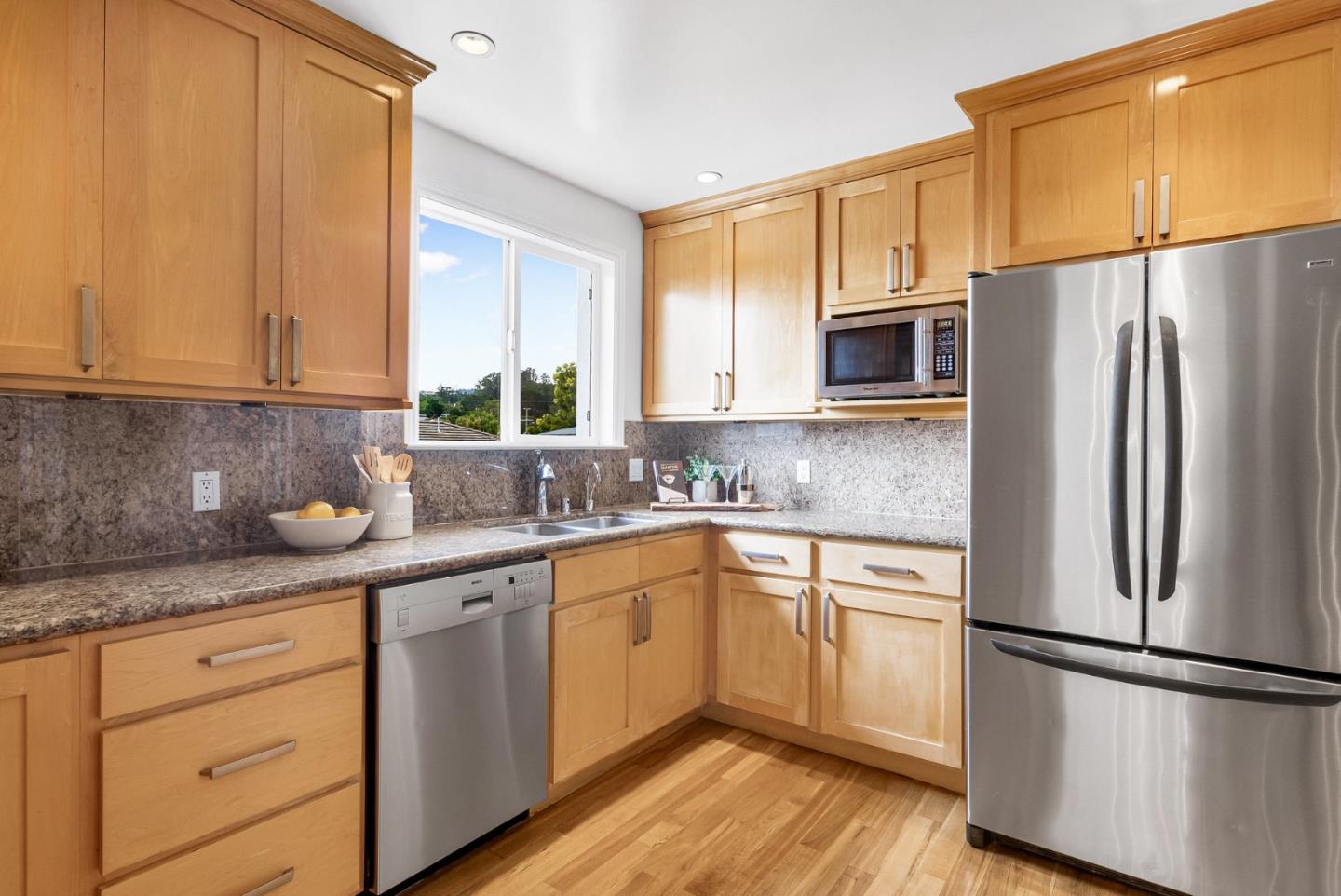 511 Bayview Avenue Millbrae, CA 94030 - Photo 17 of 36 a kitchen with a refrigerator sink and cabinets