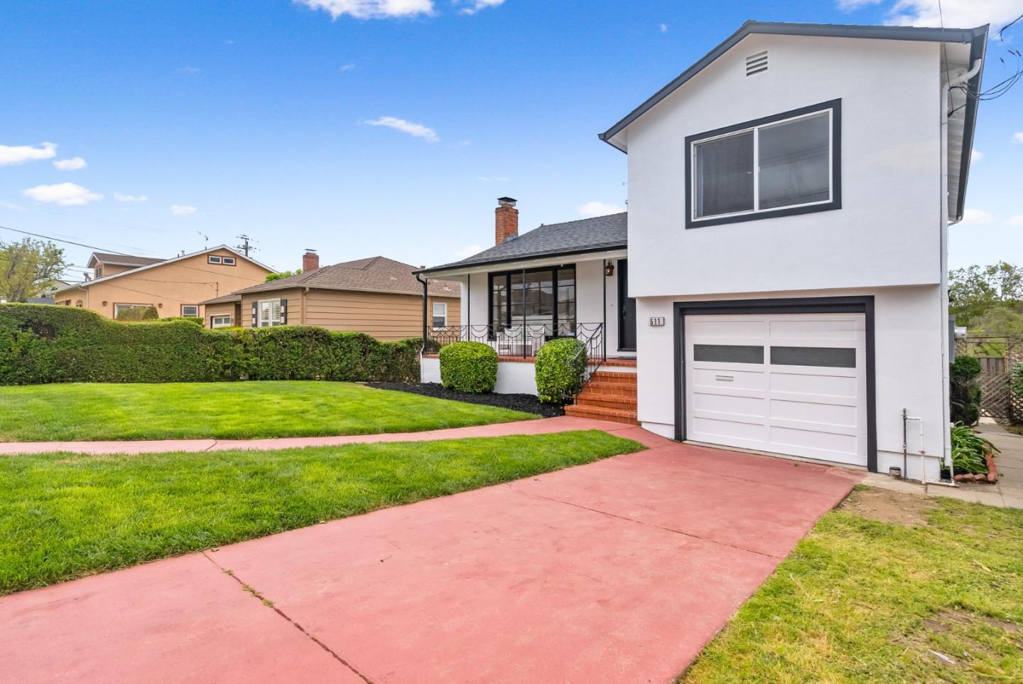 511 Bayview Avenue Millbrae, CA 94030 - Photo 2 of 36 a front view of a house with a yard and garage