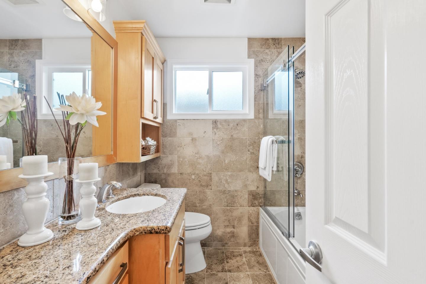 511 Bayview Avenue Millbrae, CA 94030 - Photo 26 of 36 a bathroom with a granite countertop sink a mirror and a shower