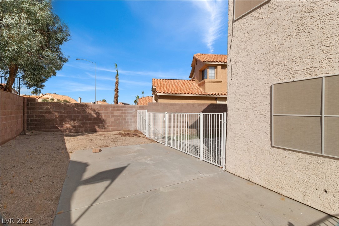 3156 Terrace View Drive Laughlin, NV 89029 - Photo 58 of 94 A spacious backyard patio with block wall and white fencing for outdoor enjoyment.