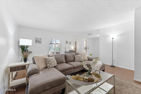a living room with furniture and wooden floor