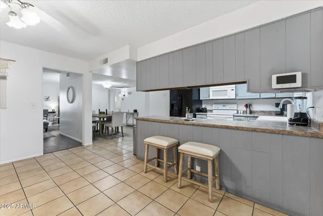 a kitchen with stainless steel appliances kitchen island granite countertop a sink and cabinets