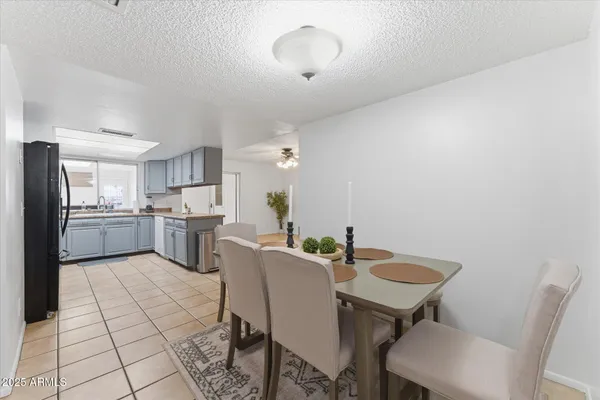 a view of a dining room with furniture and a chandelier