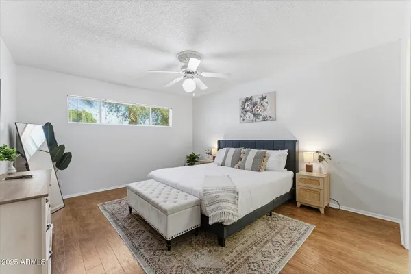 a bedroom with a bed and a chandelier