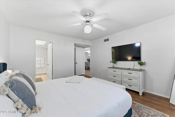 a bedroom with a bed and a flat screen tv