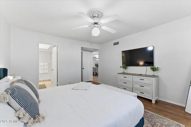 a bedroom with a bed and a flat screen tv