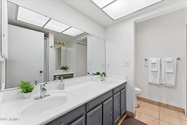 a bathroom with a double vanity sink mirror double and shower