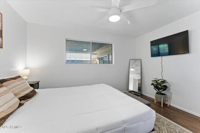 a bedroom with a bed and a potted plant