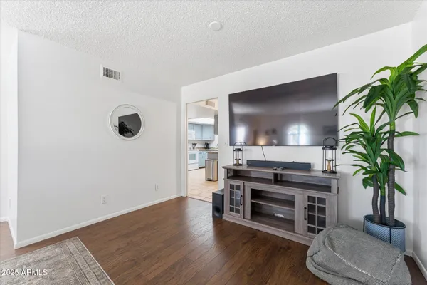 a view of a livingroom with furniture and a potted plant