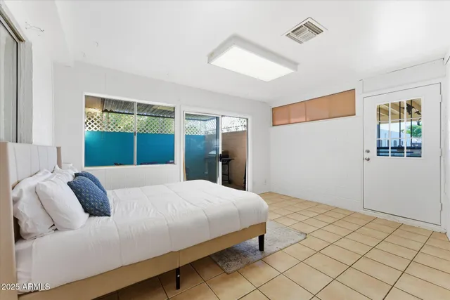 a bedroom with a large bed and a window