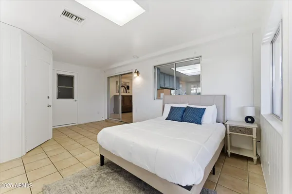 a bedroom with a bed and a table