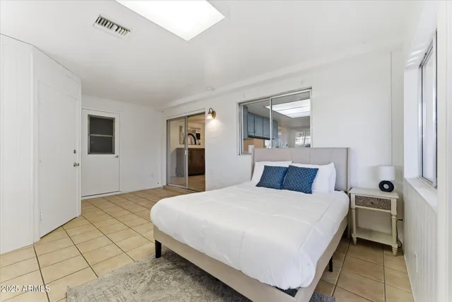 a bedroom with a bed and a table