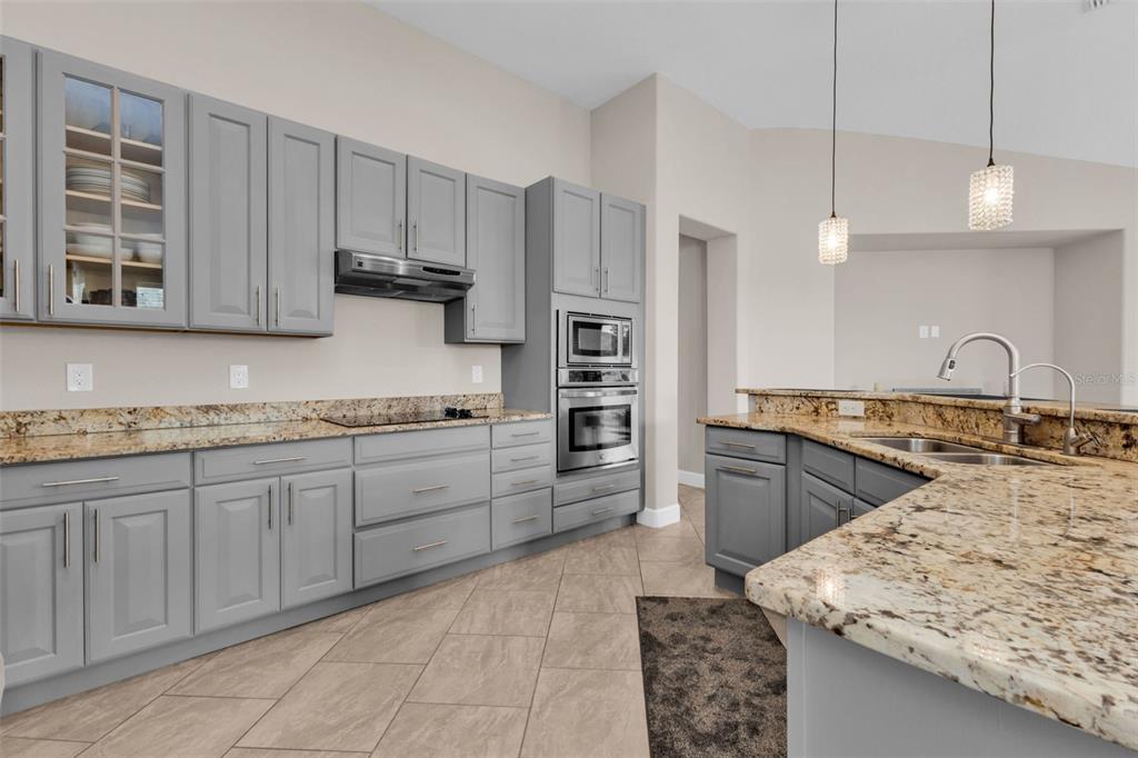 25409 Durango Court Punta Gorda, FL 33955 - Photo 16 of 46 a kitchen with kitchen island granite countertop a sink stove and refrigerator