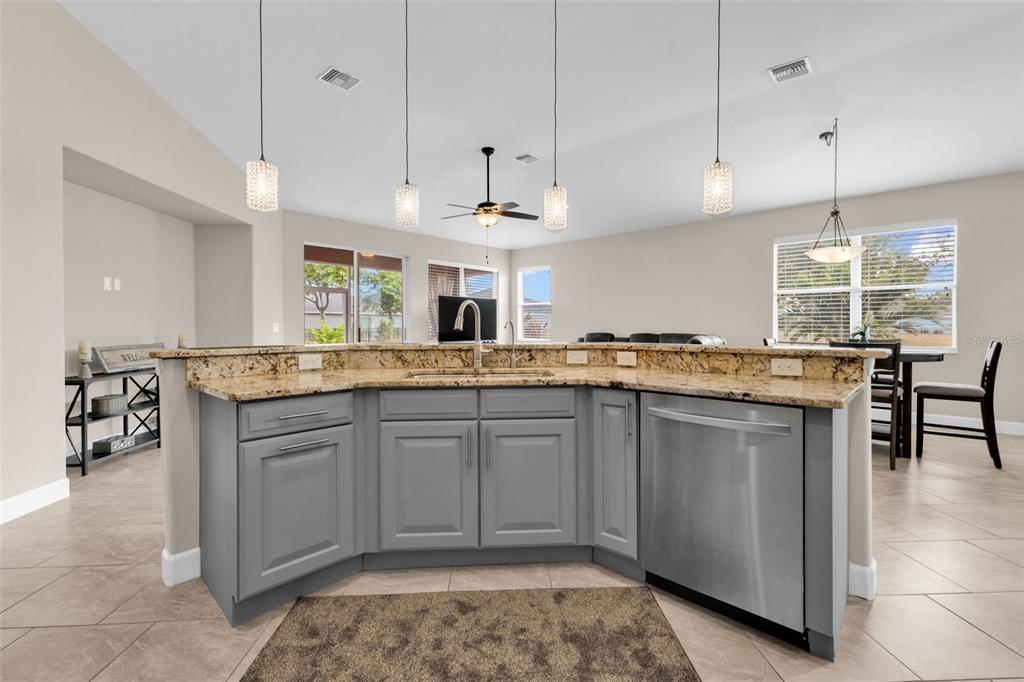 25409 Durango Court Punta Gorda, FL 33955 - Photo 18 of 46 a kitchen with granite countertop cabinets a sink a island and windows