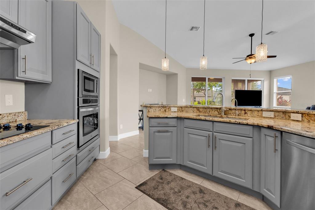 25409 Durango Court Punta Gorda, FL 33955 - Photo 19 of 46 a large kitchen with stainless steel appliances granite countertop a stove and a sink