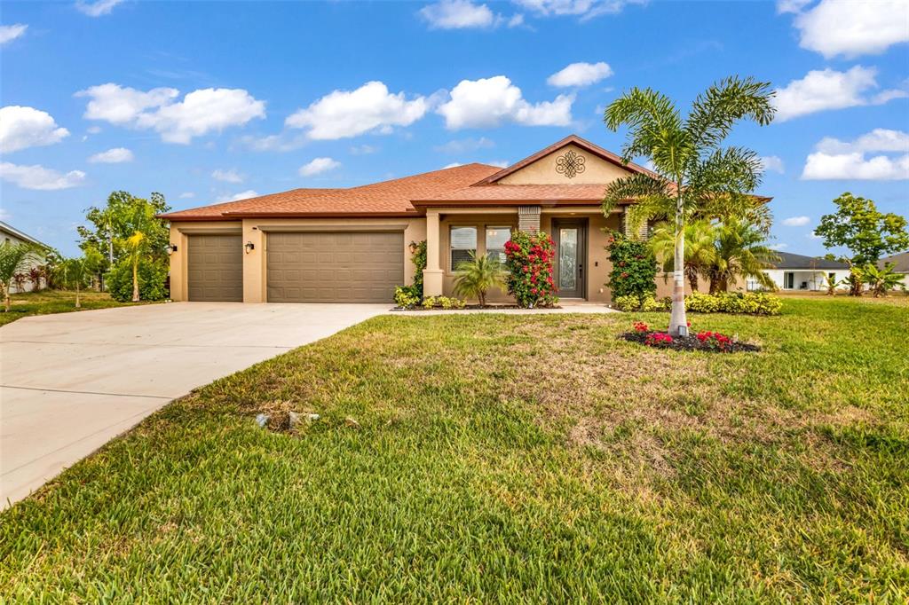 25409 Durango Court Punta Gorda, FL 33955 - Photo 2 of 46 a front view of a house with a yard
