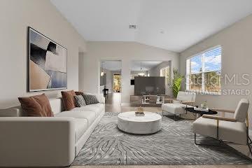 25409 Durango Court Punta Gorda, FL 33955 - Photo 5 of 46 a living room with furniture and a flat screen tv