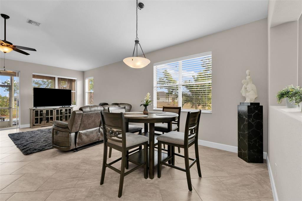 25409 Durango Court Punta Gorda, FL 33955 - Photo 9 of 46 a view of a dining room with furniture window and wooden floor