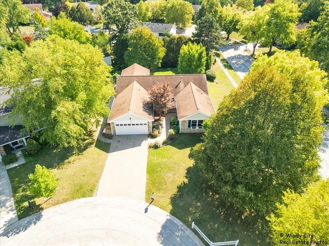 a view of a house with a yard and a garden