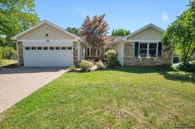 a view of a house with a yard and large trees