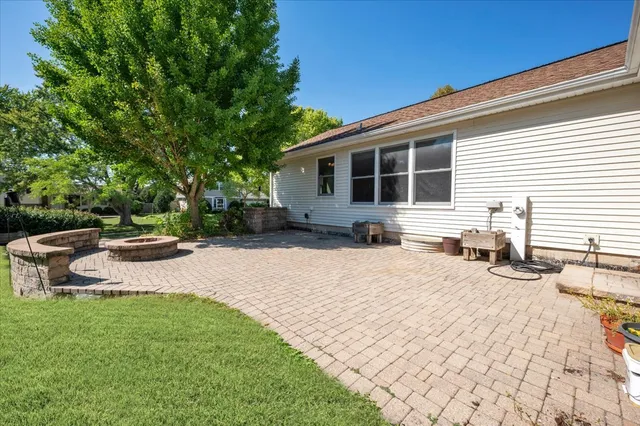 a view of a backyard with table and chairs