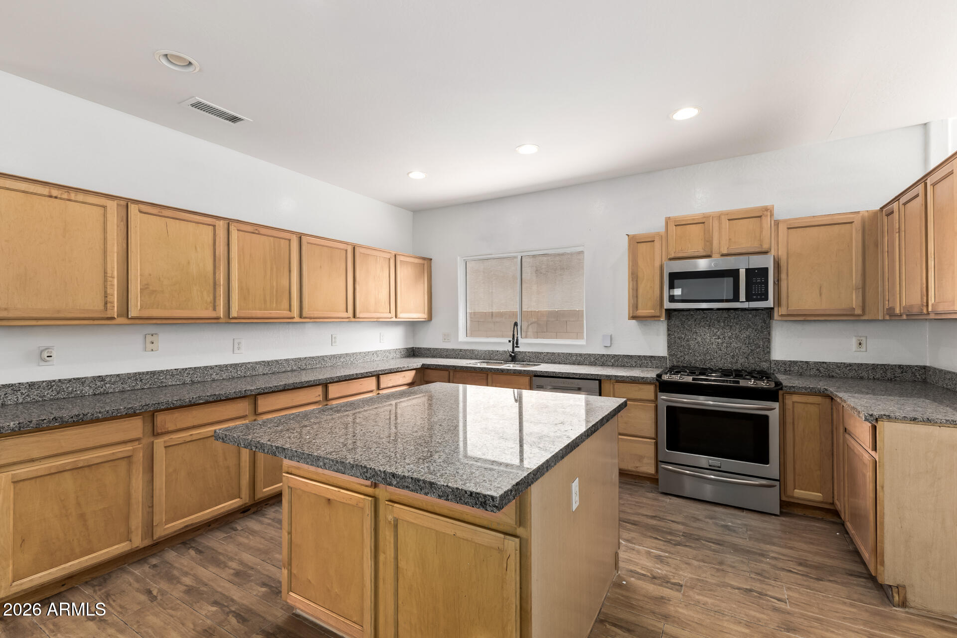 8320 West Apache Street Tolleson, AZ 85353 - Photo 11 of 31 a kitchen with a stove sink and cabinets